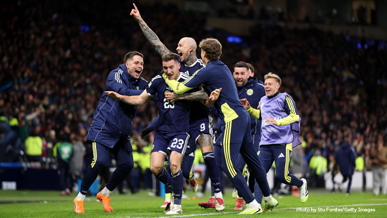 This image shows players from Scotland's men's team celebrating after securing a place at World Cup 2026
