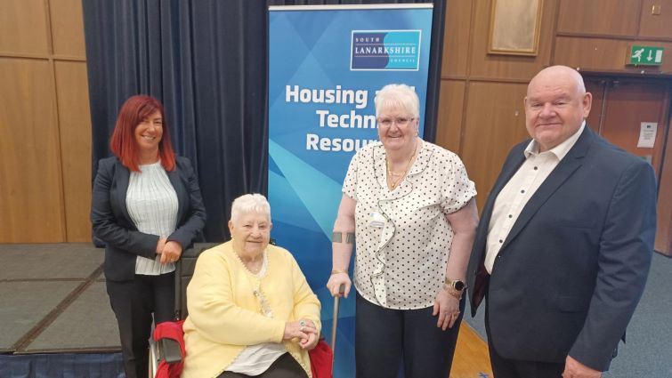 This image shows Councillor Davie McLachlan and Sharon Egan with two attendees of the Customer Voices Conference