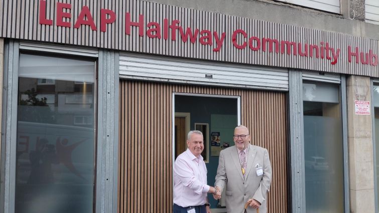 This image shows Provost Bert Thomson at the entrance of Halfway Community Hub with a member of the LEAP staff