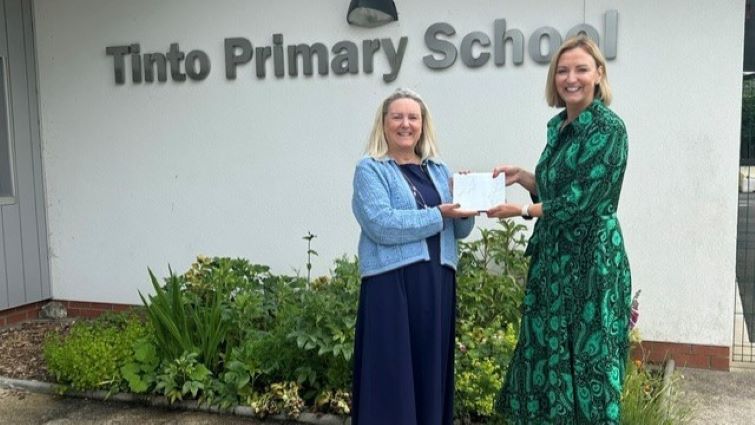 This image shows Tinto Primary School head teacher Alex Stark receiving her lifetime achievement award from Executive Director of Education Resources, Lyndsay McRoberts