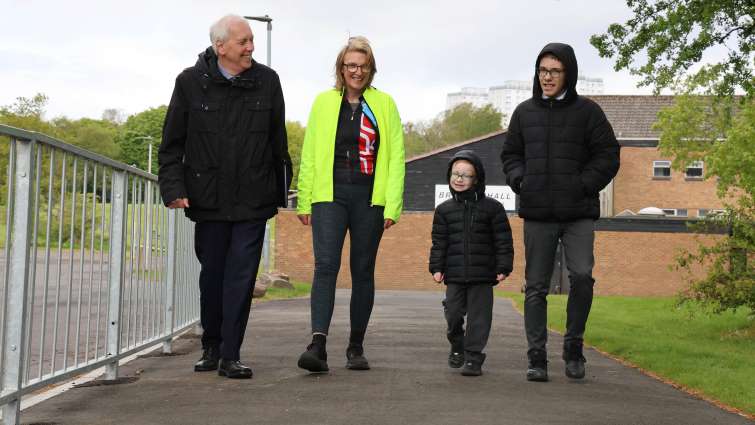 Pupils from St Leonards Primary walking along new path between their school and the local leisure facilities with Councillor Kirsten Robb and Councillor Robert Brown